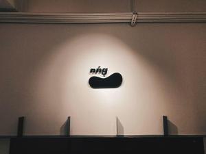 a wall with a mng sign on a wall at 軟寓 nńg inn in Tainan