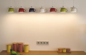 a row of lights on a wall above a table at Somewhere - Estoril Guesthouse in Estoril