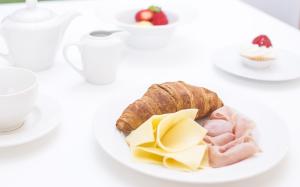 a plate of food with bread and meat and cheese at Somewhere - Estoril Guesthouse in Estoril