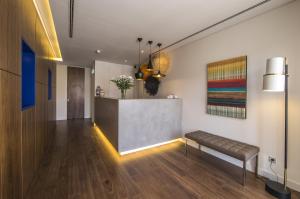 a lobby with a bench and a reception desk at Somewhere - Estoril Guesthouse in Estoril