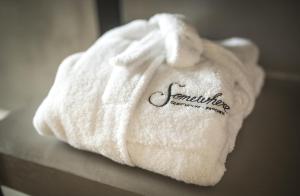 a white towel with the word earthquakechange written on it at Somewhere - Estoril Guesthouse in Estoril