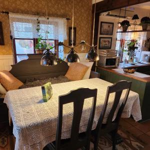 a kitchen with a table with a tablecloth on it at Smultronbacken in Eljaröd