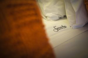 a close up of the word sympathy written on a bed at Somewhere - Estoril Guesthouse in Estoril