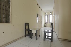 a room with a table and two chairs in it at Hotel O Guest House Sae Madani in Sepaku +37 photos