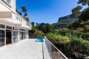 a view from the balcony of a house with a swimming pool at Elite Retreats - Hillside Villa 2 - power backup in Cape Town