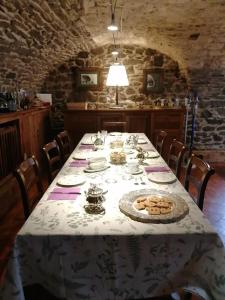 a dining room with a table with a white table cloth at La Thuillettaz B&B in Saint-Rhémy-en-bosses