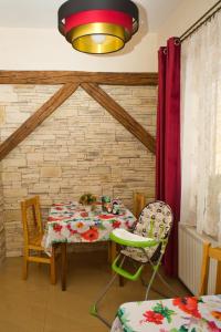 a dining room with a table and two chairs at Dobra Miejscówka in Krynica Zdrój