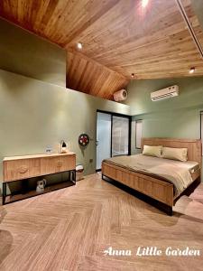 a bedroom with a large bed and a wooden ceiling at Anna Little Garden - Homestay Sóc Sơn - Thong House in Hanoi