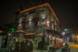 a building on a street at night at Patriko Mountain Chalet in Palaios Agios Athanasios