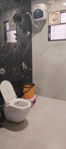 a bathroom with a toilet and a wall at Hotel Ajanta green restaurant and resort in Phardāpur
