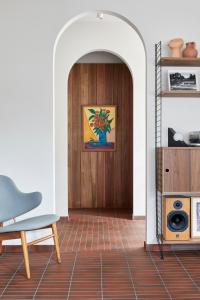 a room with a door with a chair and a table at Months and Seasons Design-led Country House in Daylesford