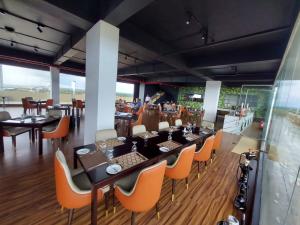 a restaurant with a long table and chairs at Ocean Breeze Studios in Negombo