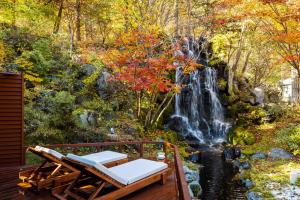 a waterfall mural in front of a deck with two beds at Noboribetsu Grand Hotel in Noboribetsu