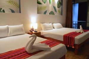 Postel nebo postele na pokoji v ubytování Hotel Axolotl