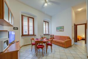 a kitchen and a living room with a table and chairs at Casa Alpino - Happy Rentals in Riva del Garda