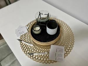 a table topped with a tray with a tea pot and cups at Roomino Apartment in Vienna