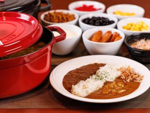 a table with a pot of chili and a plate of food at Hotel Villa Fontaine Tokyo-Nihombashi Mitsukoshimae in Tokyo