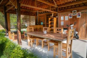 a wooden table and chairs in a house at Kubu Sakian Villa and Restaurant Sidemen in Sidemen