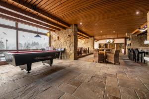 a large room with a pool table and a bar at Grand Hotel rooms in Spišské Tomášovce