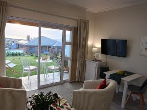 a living room with a large sliding glass door to a patio at C-Vista in Stilbaai-Wes
