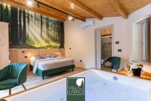 a bedroom with a bed and a tub at Villa dei Larici in Camigliatello Silano