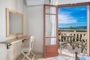 a room with a desk and a window and a balcony at Minas Studios in Lassi