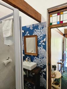 a bathroom with a sink and a mirror at The Riverdeck Accommodation and Backpackers in Knysna