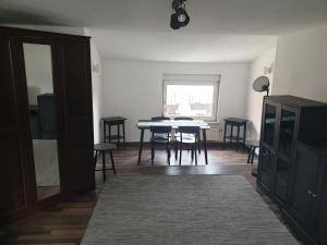 a living room with a dining room table and chairs at Mimalou Apartment in Meerane in Meerane