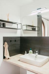 a bathroom with a sink and a mirror at Ferienwohnungen Marcushof in Bad Wörishofen