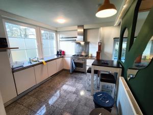 a kitchen with a sink and a stove top oven at Three bedroom apartment in Heerlen in Heerlen