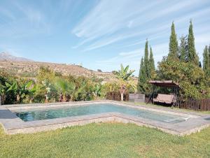 a swimming pool in the middle of a yard at Villa Aguacate in Nerja