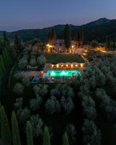 an aerial view of a house with a pool at night at La Tuscia - Tenuta Di Toscana, Boutique Villa in Gaiole in Chianti