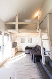 a living room with a couch and a loft bed at LUZ in Sierra Nevada