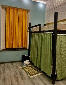 a bedroom with a bunk bed with green and yellow curtains at Communication hostel in Batumi