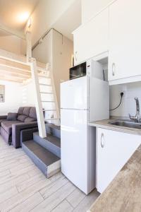 a kitchen and living room with a loft bed at LUZ in Sierra Nevada