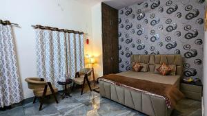 a bedroom with a bed and a table and a chair at Prakriti Homestay in Roorkee