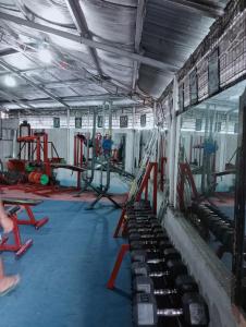 a gym with a bunch of equipment in it at QUICKSHIELD HOMESTAY in Naga