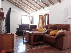 a living room with a couch and a table at Villa Aguacate in Nerja