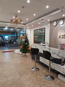 a lobby with a christmas tree in the middle at A25 Hotel - 30 An Dương in Hanoi