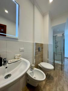 a bathroom with a tub and a toilet and a sink at Villa Angela Suite in Taranto