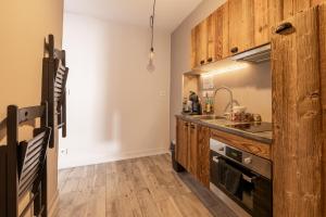 a kitchen with wooden cabinets and a sink at Love Loft in Bordeaux