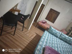 an overhead view of a living room with a table and chairs at Ha Lad in Mawlynnong