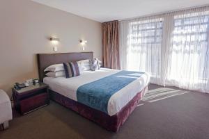 Voodi või voodid majutusasutuse Mantra Collins Hotel toas