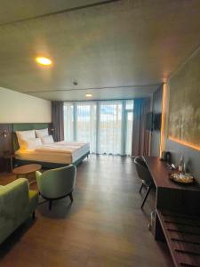 ein Hotelzimmer mit einem Bett, einem Schreibtisch und Stühlen in der Unterkunft DX Apartments in Berlin