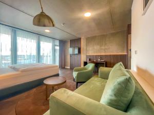 a hotel room with a bed and a couch at DX Apartments in Berlin
