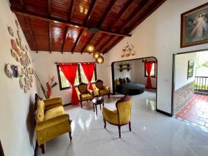 uma sala de estar com cadeiras amarelas e um sofá em Acogedora casa de campo con excelente ubicación em Carmen de Viboral