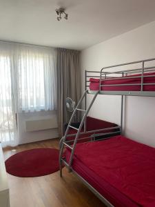 - une chambre avec 2 lits superposés et des draps rouges dans l'établissement Neon Gondola apartment, à Bansko