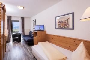 ein Hotelzimmer mit einem Bett und einem Stuhl in der Unterkunft Allgäuer Bergbad in Oberstdorf