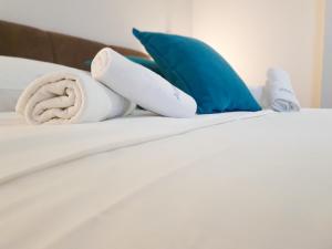 a bed with towels and pillows on it at Hotel Wellness&Spa Astorya Banja Luka in Banja Luka