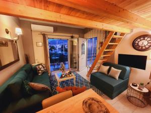 a living room with a couch and a staircase at Luxury Loft Apartment Sofia in Patra